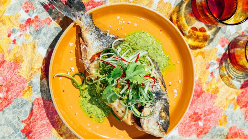 there is a cooked fish on a yellow plate