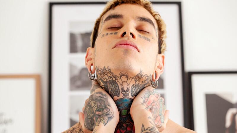A person holds their neck