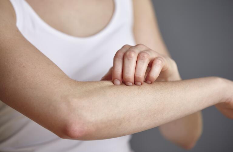 woman-running-hand-across-arm