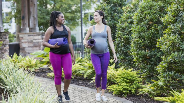Two pregnant women walking to yoga class 