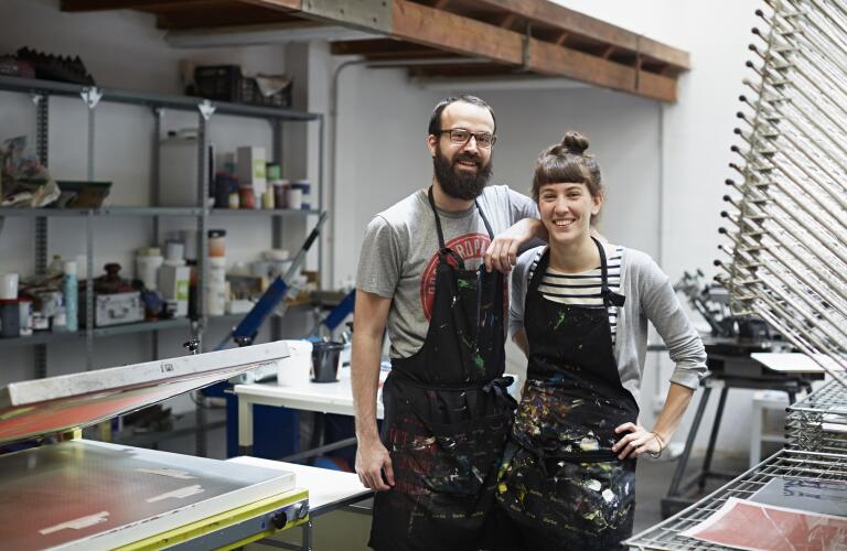 Couple smiling together at silk screen workshop