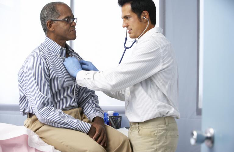 Doctor listening to patient's heart