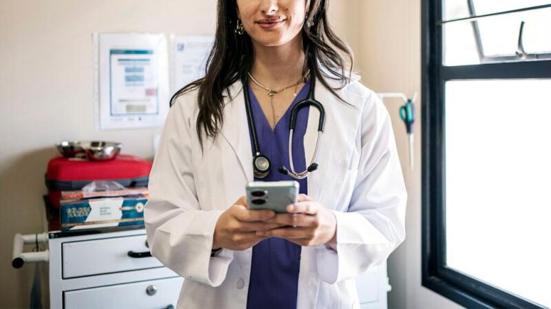 Female doctor holding phone