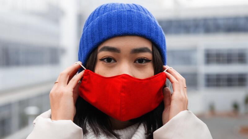 Woman putting on a cloth mask