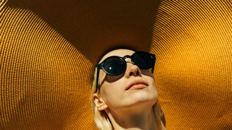 Woman wearing a sunhat and sunglasses