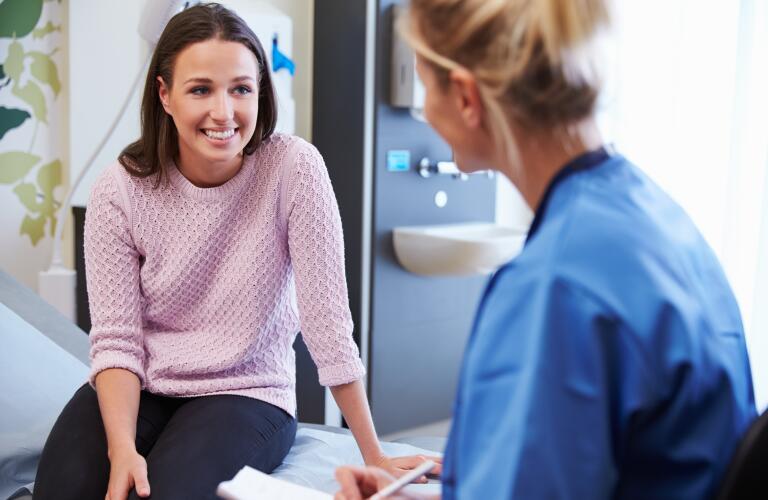smiling female patient speaking with female doctor