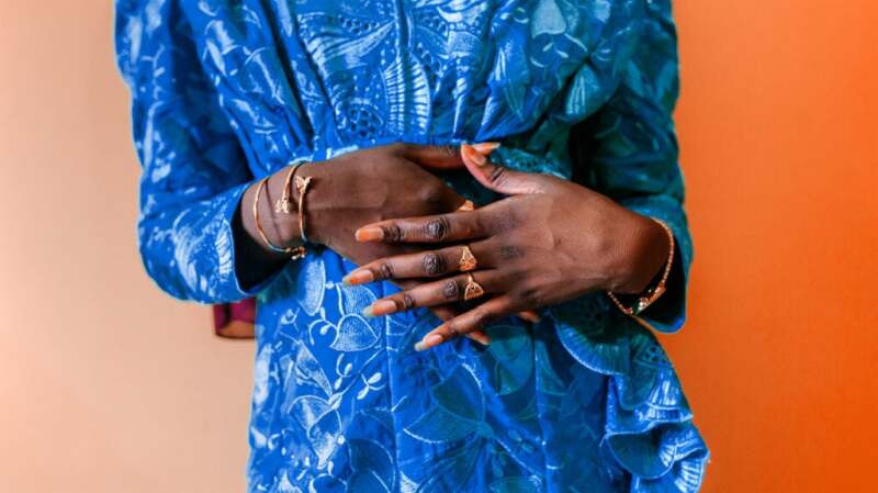 a person with clammy skin is clasping their hands together