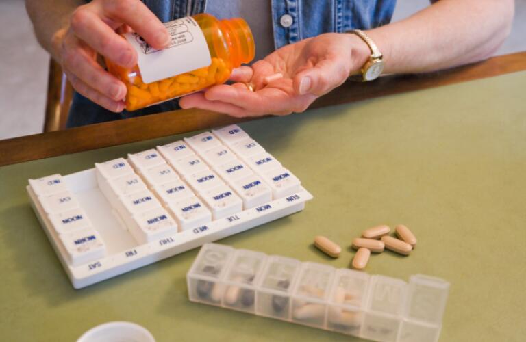 Middle-aged woman taking pills