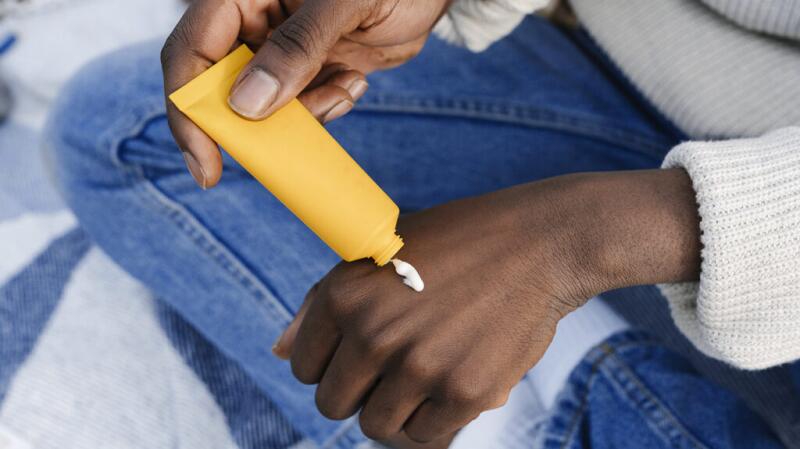 A person is applying hand cream.