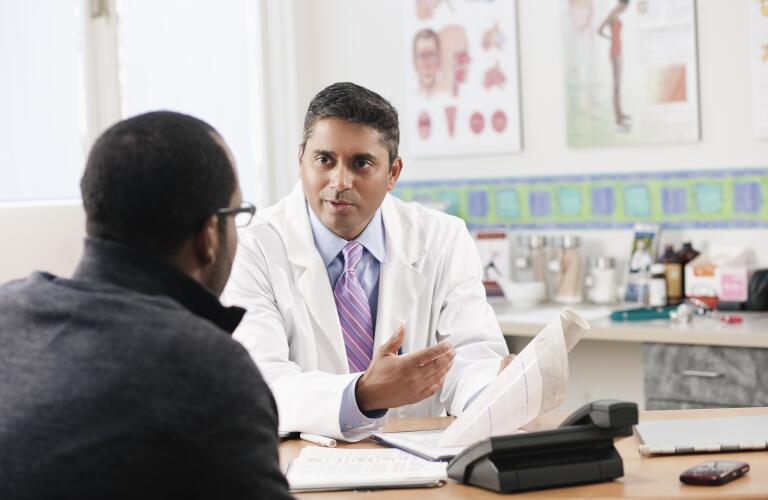Doctor talking to patient in doctor's office