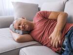 Man on couch with stomach pain