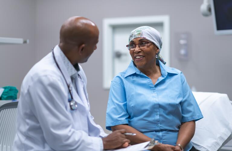 senior age black woman with cancer in medical consultation