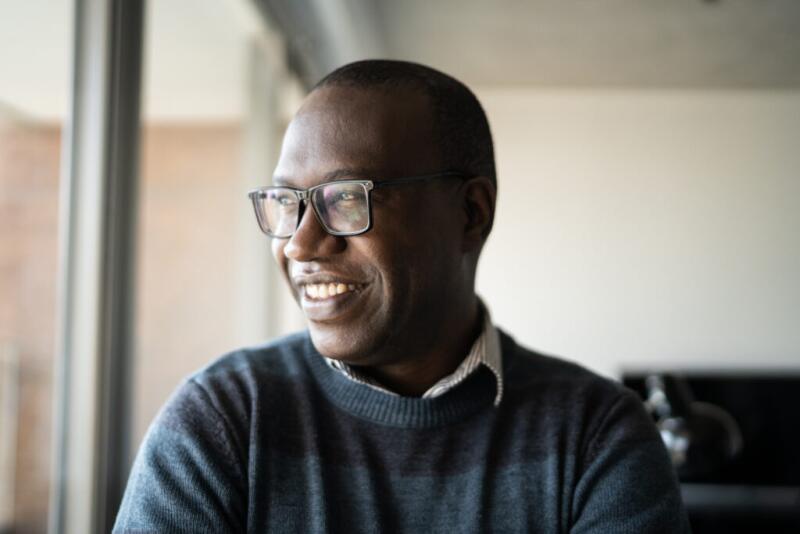 Happy mature man contemplating at home