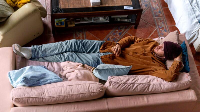 A person is lying down with their hand on their stomach.