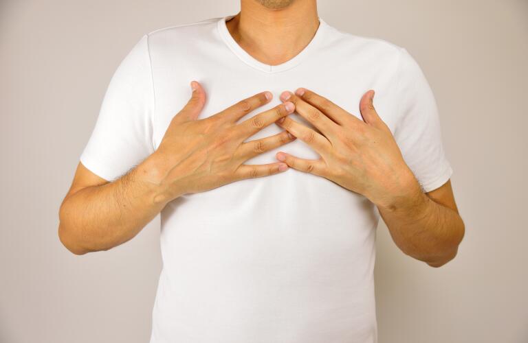 man with hands on chest