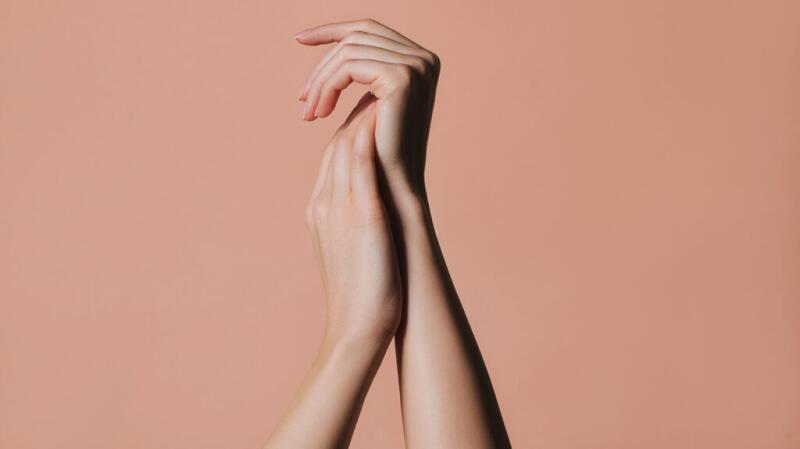 Image of hands rubbing together against an orange background