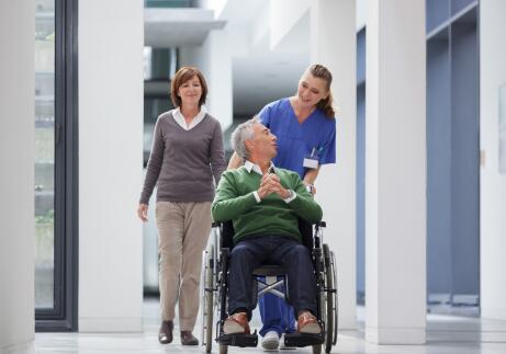Hospital-staff-with-disable-patient-in-wheelchair