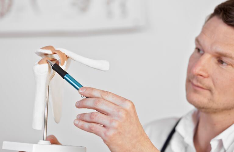 doctor-pointing-at-model-of-rotator-cuff