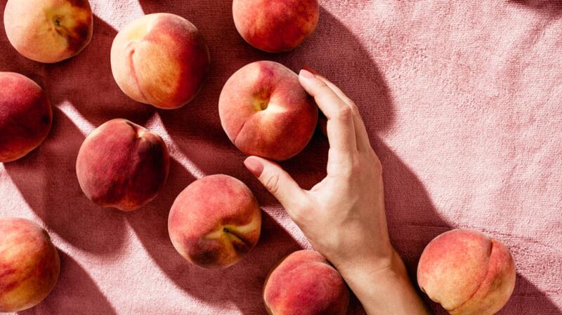 hand holding peaches