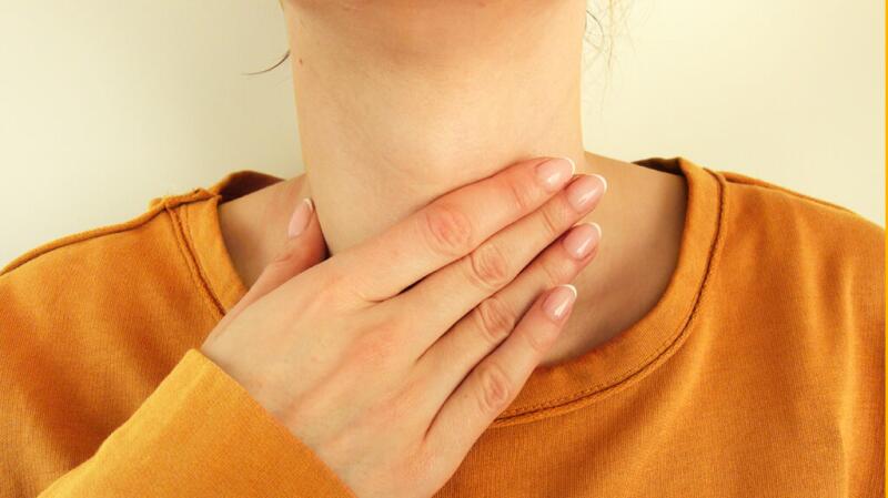 Someone holding their neck