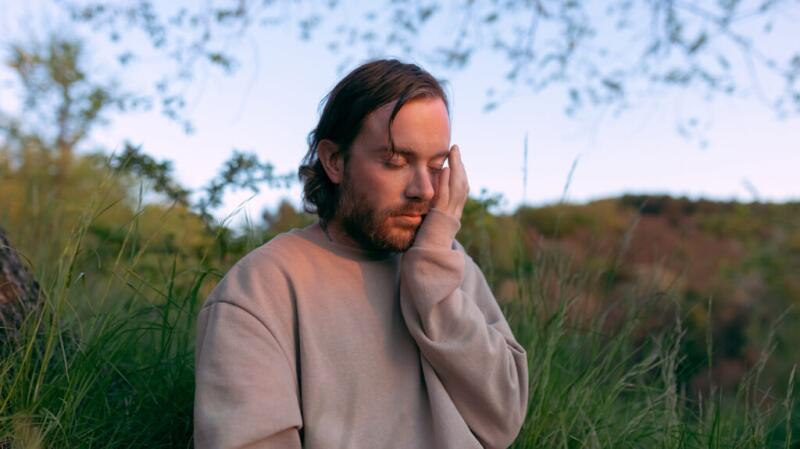 A man touching his face