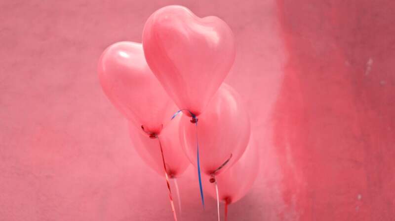 A collection of pink heart-shaped balloons