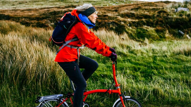 An older woman riding her bicycle