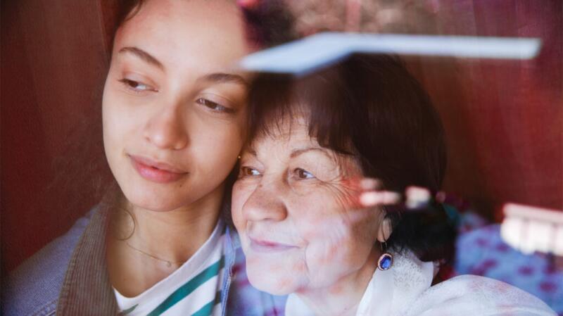 Younger woman hugging an older woman