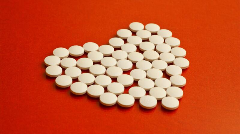 Pills organized in a heart shape