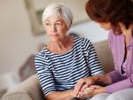 senior woman holding hands of caregiver