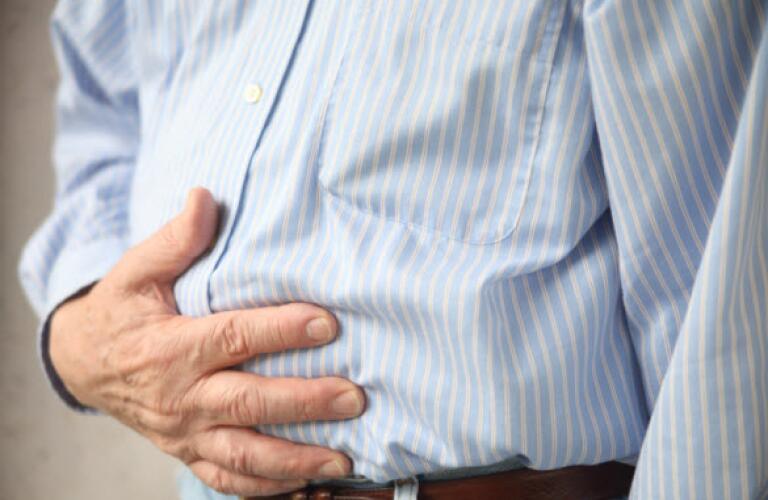 Man clutching stomach