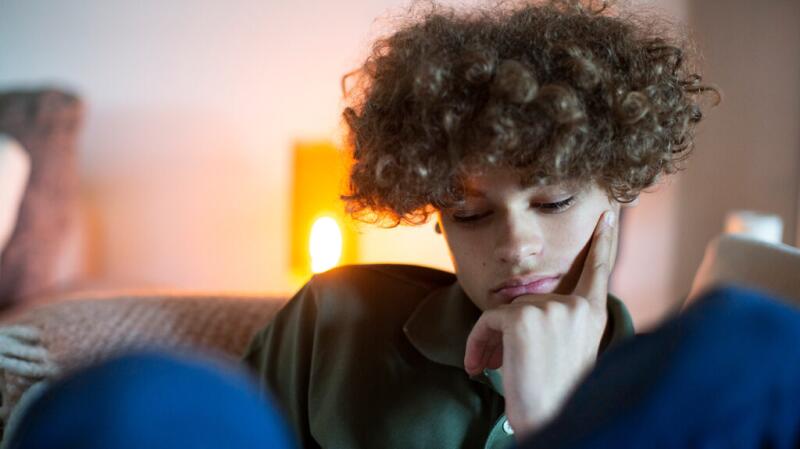 Younger male looking pensive