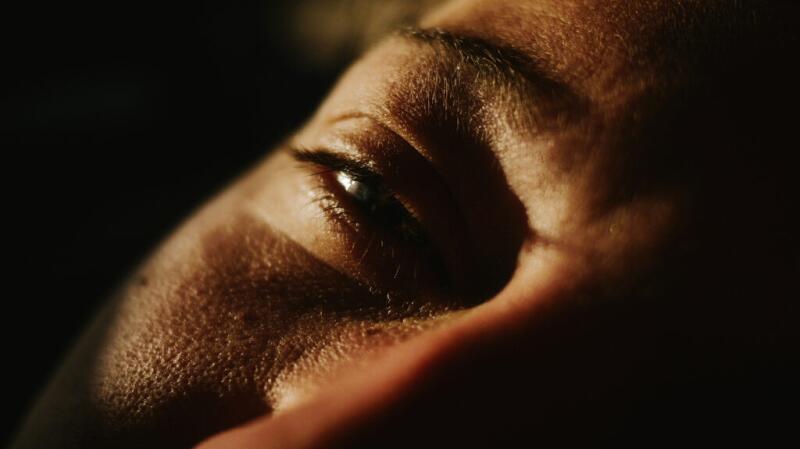 A close-up of a person's eye in direct sunlight.