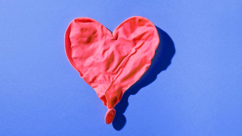 there is a deflated heart shaped balloon