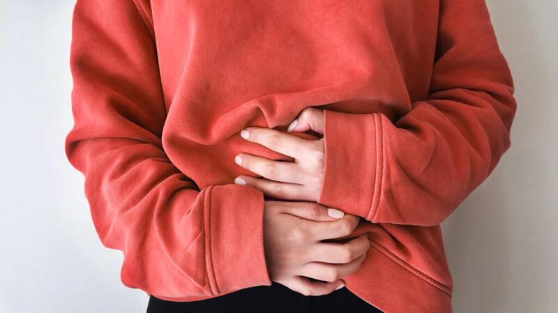 A person is clutching their stomach.
